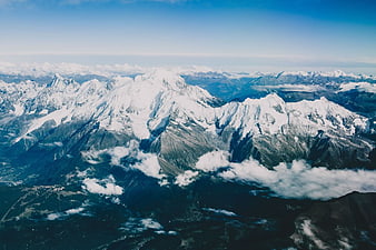 Aerial View of Snow-Capped Mountain Range with Clouds