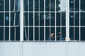 Modern building facade with grid windows and interior chairs