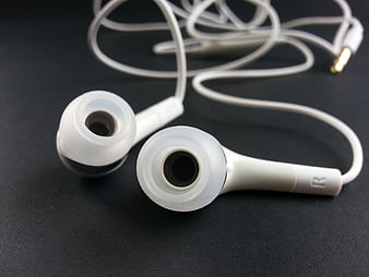 White Wired Earbuds on Dark Surface