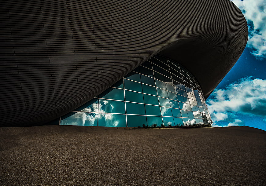 Modern Curved Architecture with Glass Facade and Blue Sky