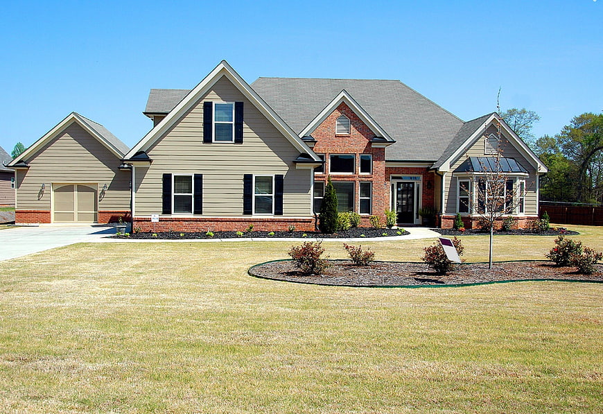 Modern suburban home with gray siding and brick accents