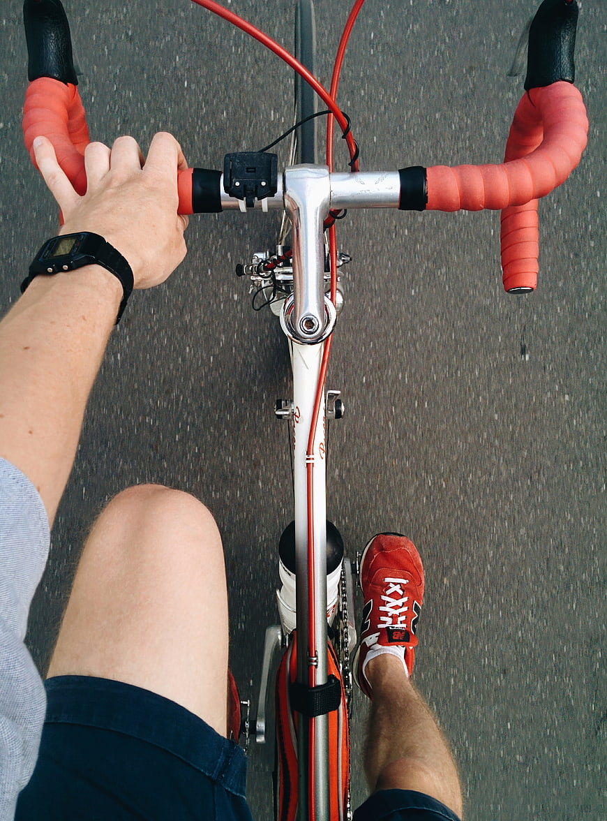 First-person view of cyclist riding road bike on asphalt