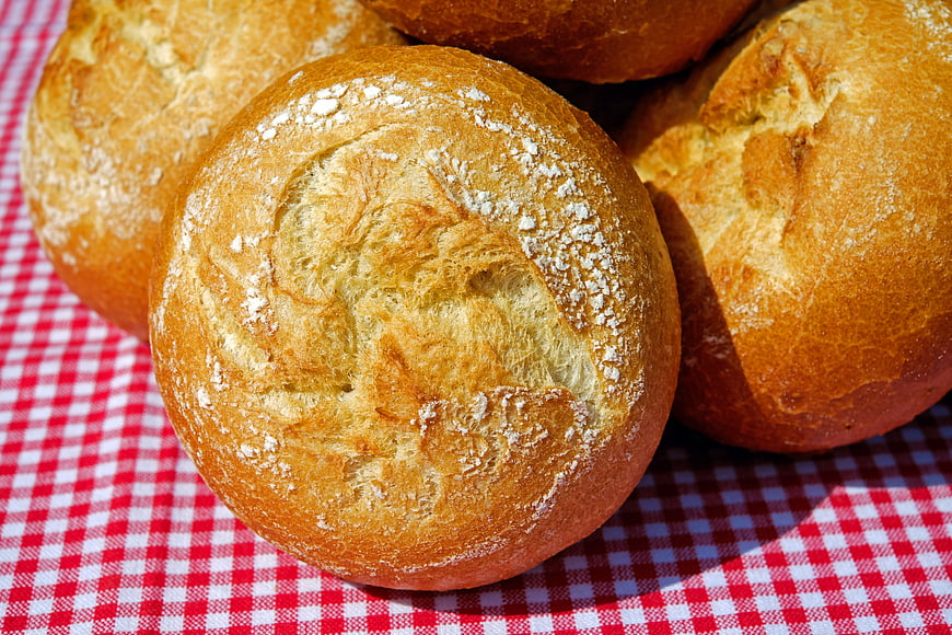Freshly Baked Bread Rolls on Red Checkered Tablecloth