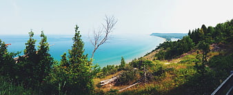 Panoramic View of Turquoise Lake and Forested Cliffside