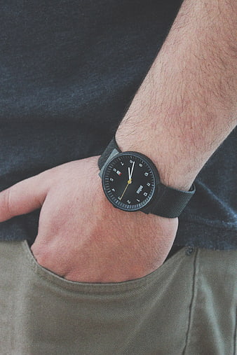 Close-up of man's wrist wearing black analog watch