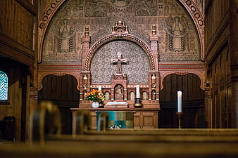 Ornate wooden church altar with cross and candles