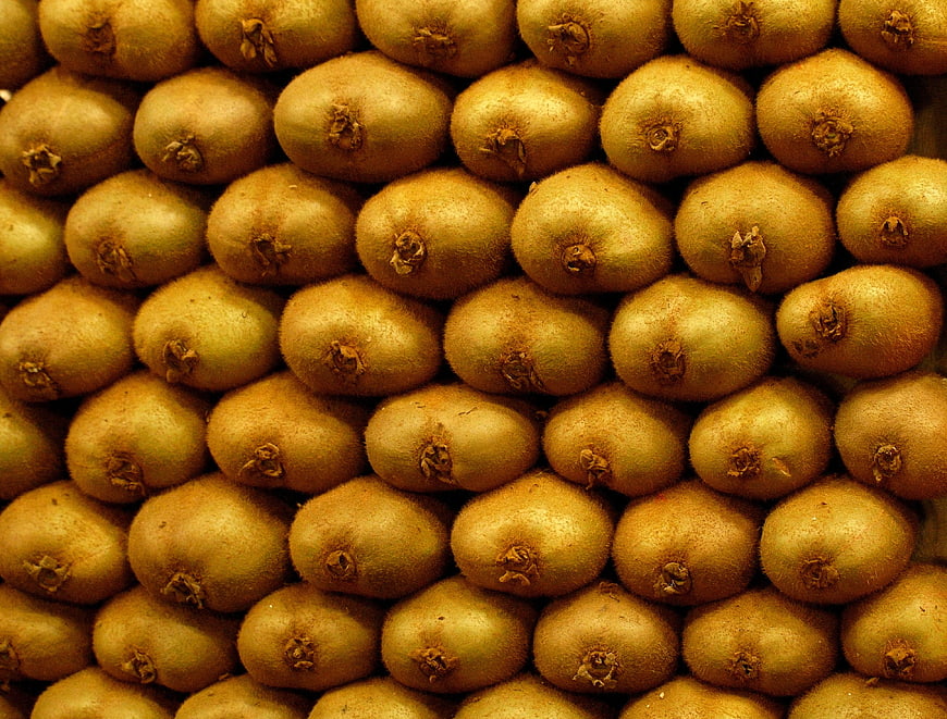 Close-up texture of stacked fresh kiwi fruits