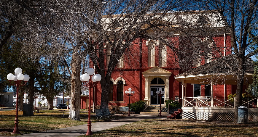 Red Brick Historic Building with Porch and Trees