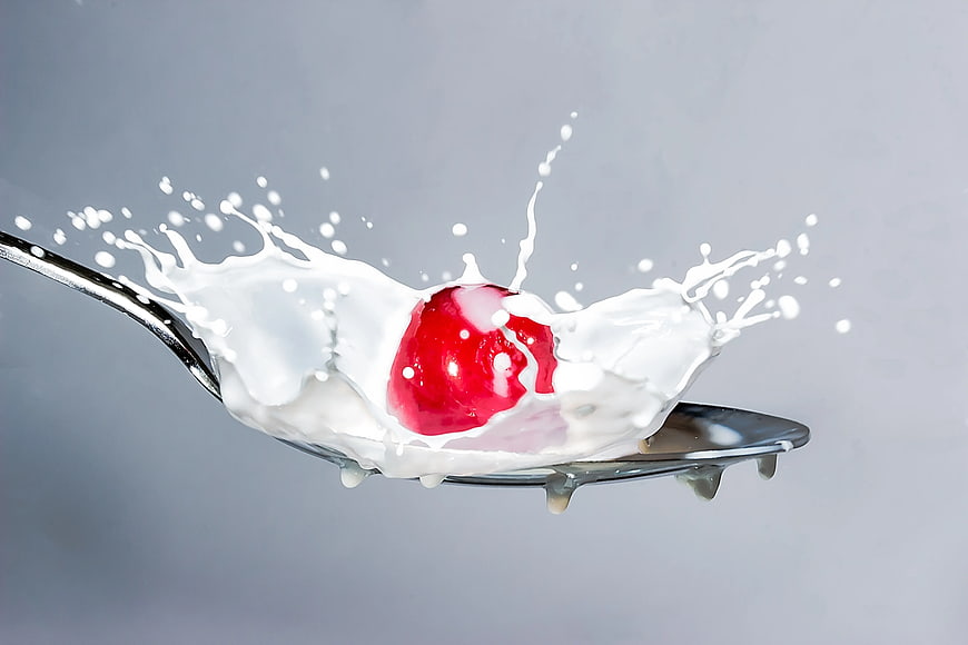 Cherry Splashing into Milk on a Spoon