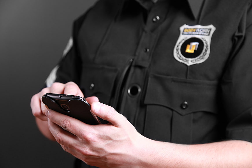 Police Officer Using Smartphone in Black Uniform