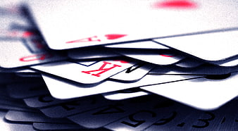 Close-up of scattered playing cards with King and Ace of Hearts
