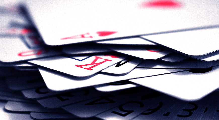 Close-up of scattered playing cards with King and Ace of Hearts