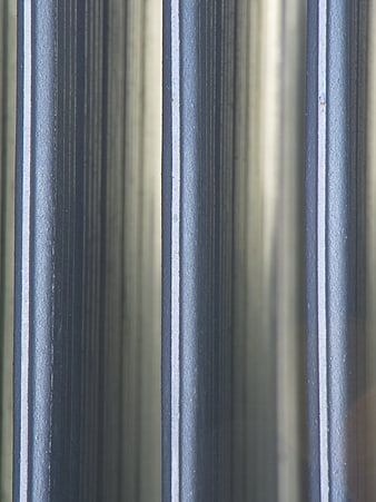 Close-up of brushed metal texture with vertical lines