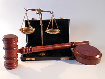 Wooden Gavel and Brass Scales of Justice on White Background