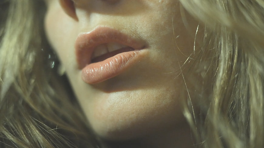 Close-up of woman's lips and blonde hair