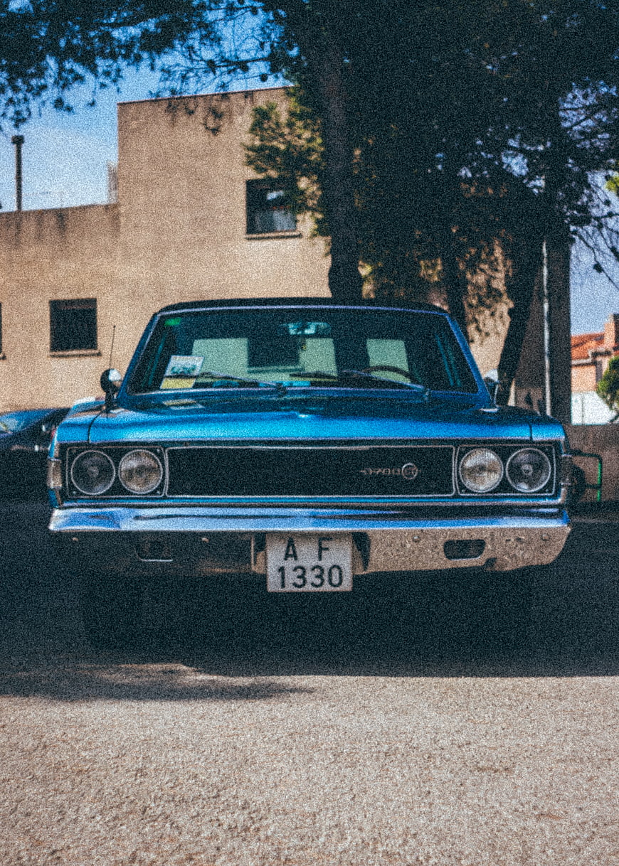 Front view of vintage blue classic car parked outdoors