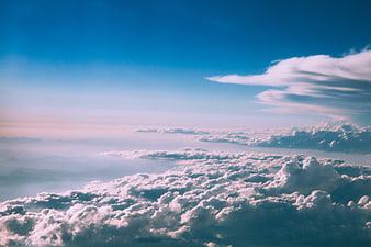 Aerial view of fluffy white clouds against a deep blue sky