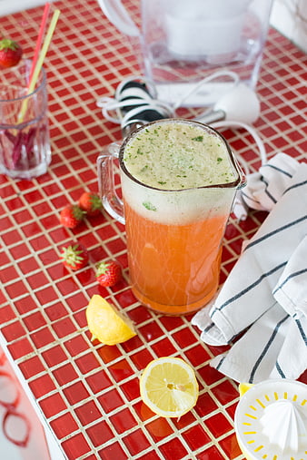 Fresh strawberry basil lemonade on red tiled counter