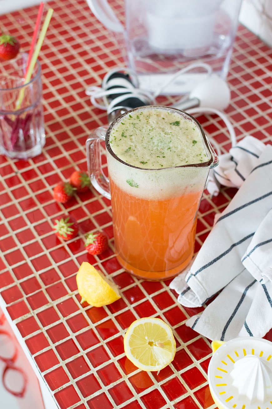 Fresh strawberry basil lemonade on red tiled counter