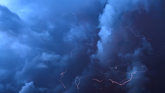 Dramatic Lightning Storm in Dark Blue Cloudy Sky