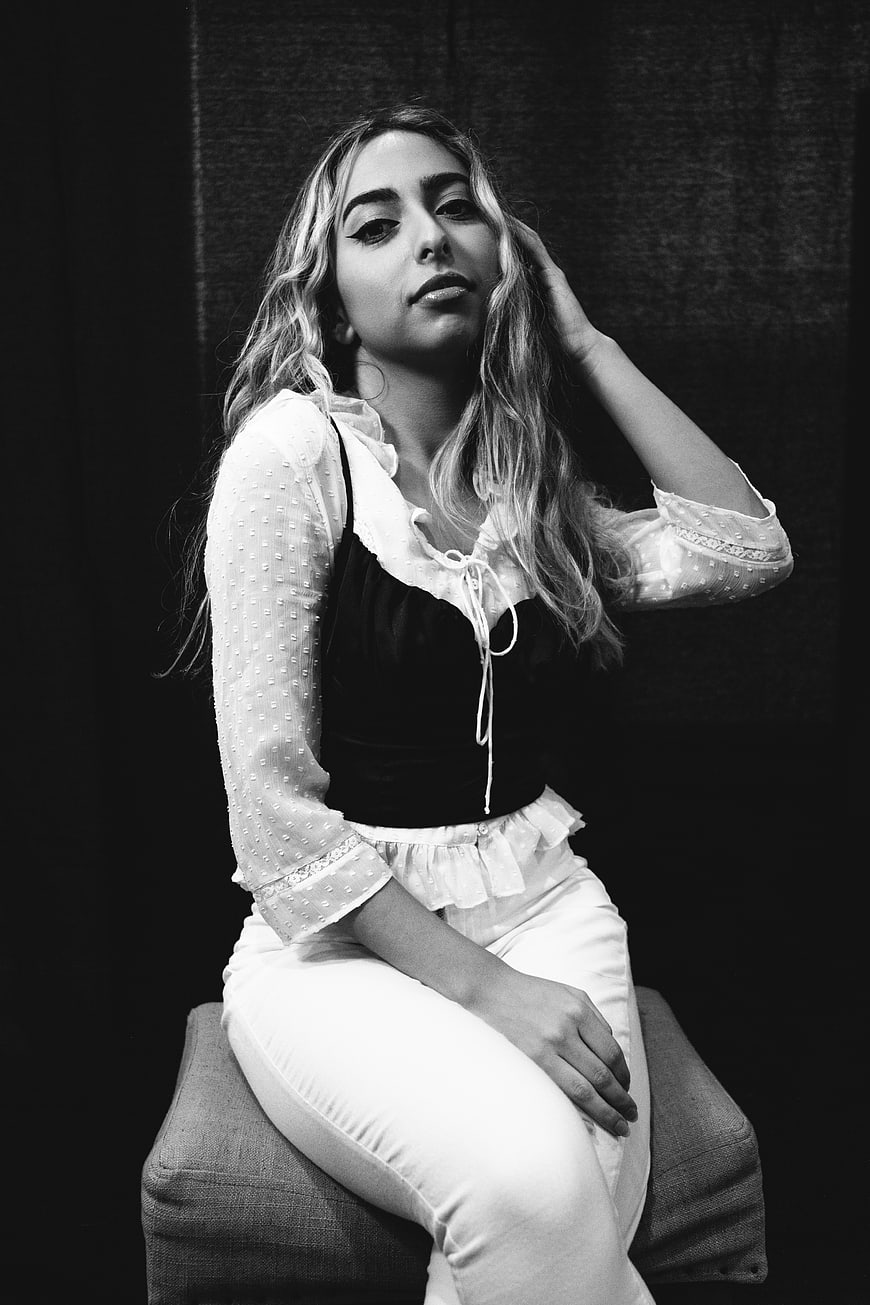 Black and white portrait of a stylish young woman posing
