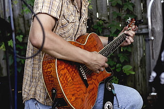 Man Playing Acoustic Guitar Outdoors