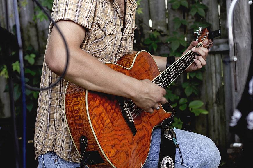 Man Playing Acoustic Guitar Outdoors