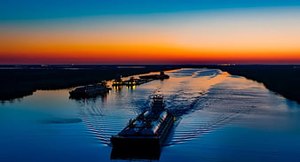 Aerial View of Barges on River at Sunset