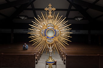 Golden Monstrance in Church with Praying Man