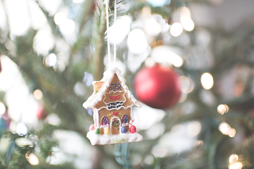 Gingerbread House Christmas Ornament on Tree with Bokeh Lights