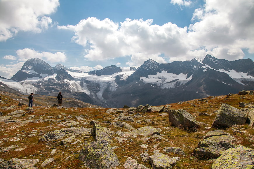 Two Hikers Viewing Snowy Mountain Glacier Landscape