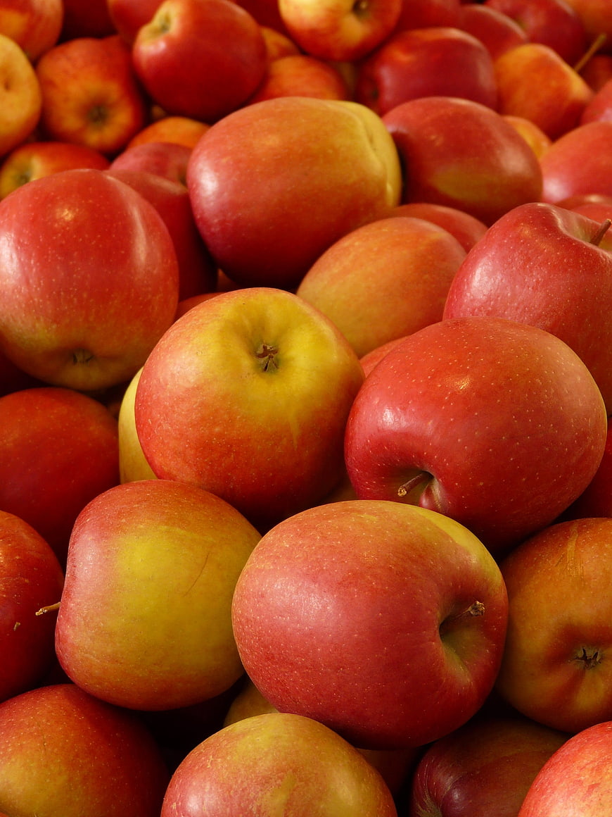 Close-up of fresh red and yellow apples piled together