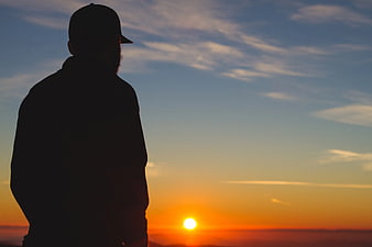 Silhouette of Man Watching Sunset Horizon