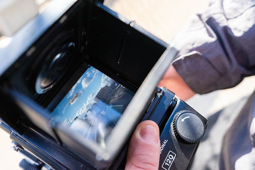 Close-up of hand holding vintage medium format film camera