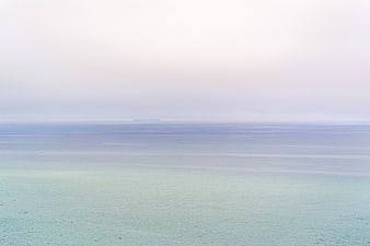 Serene Pastel Ocean Horizon with Misty Sky