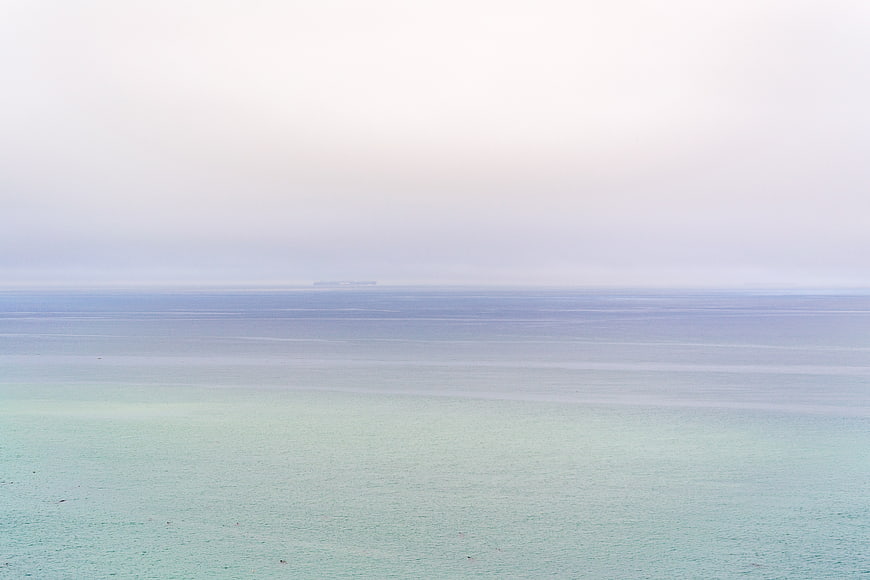 Serene Pastel Ocean Horizon with Misty Sky