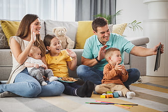 Happy family taking selfie with tablet in living room