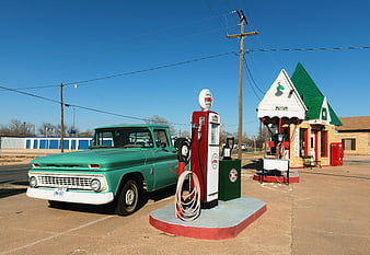 Vintage Green Pickup Truck at Retro Gas Station