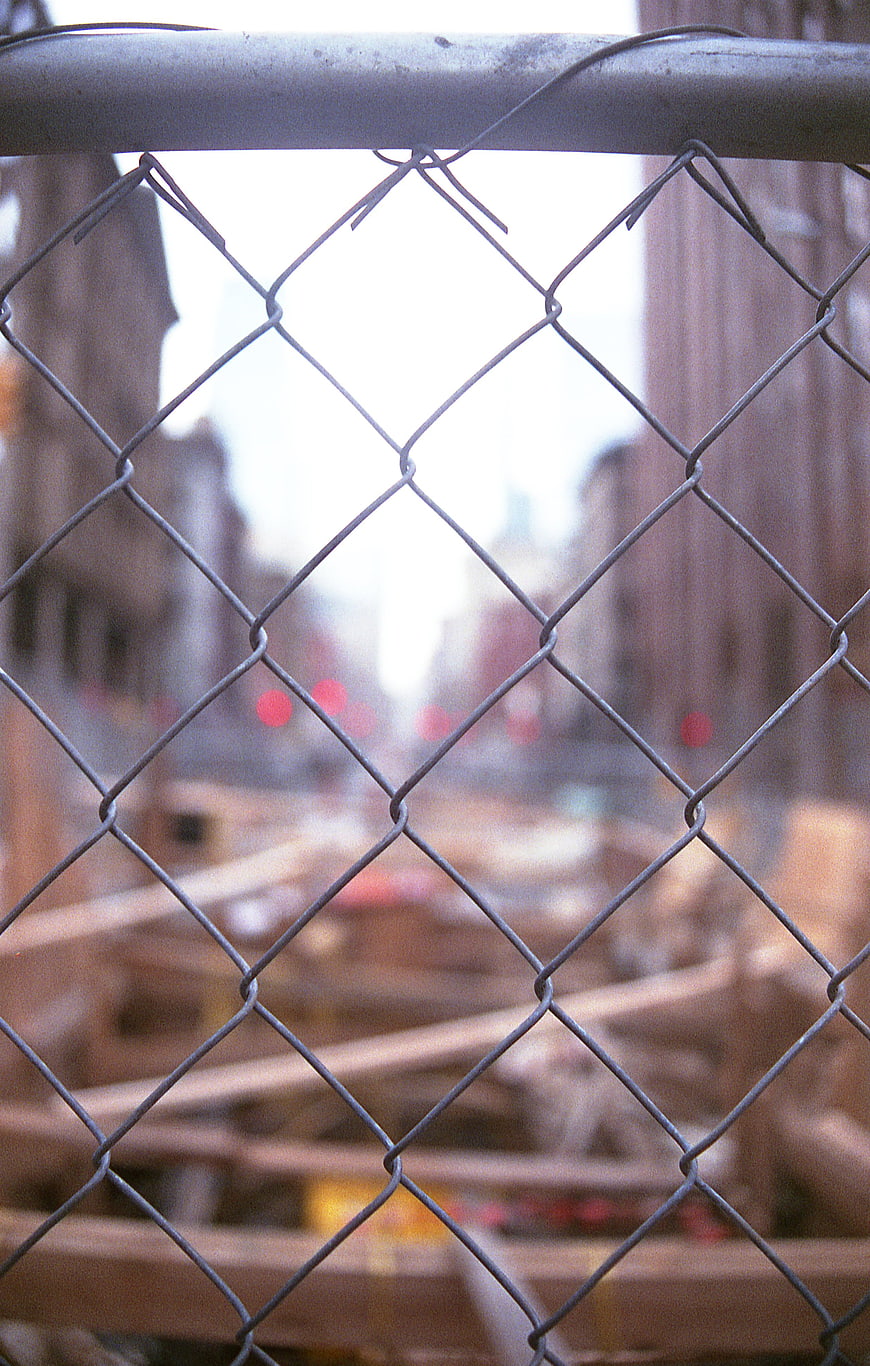Chain link fence with blurred construction site background