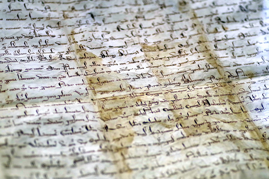 Close-up of medieval manuscript with gothic script on parchment