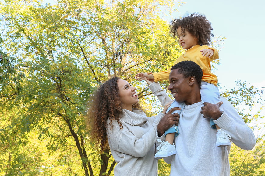 Happy African American Family Playing in Park