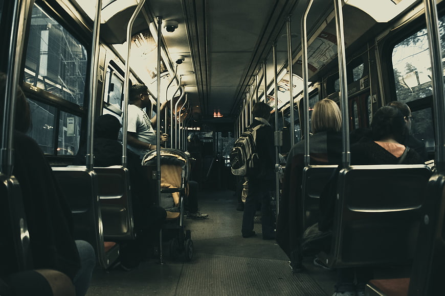 Interior of a public bus with commuters and passengers