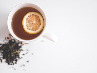 Top View of Hot Tea with Lemon Slice and Loose Leaves