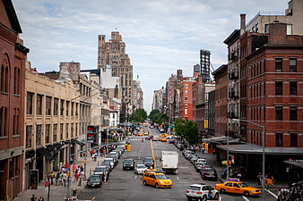 Busy New York City Street with Yellow Taxis and Brick Buildings