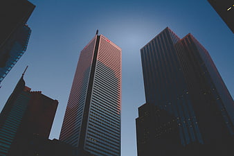 Low angle view of modern skyscrapers against blue sky