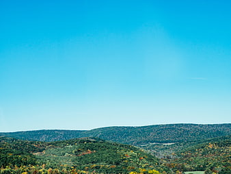 Rolling Hills Autumn Landscape Under Clear Blue Sky