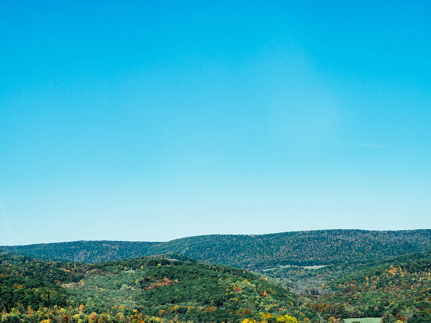 Rolling Hills Autumn Landscape Under Clear Blue Sky