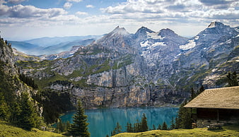 Alpine Lake Oeschinen with Mountain Reflections and Wooden Hut