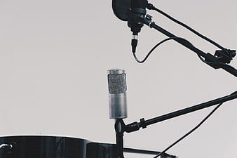 Professional Studio Microphones on Stands Against White Background