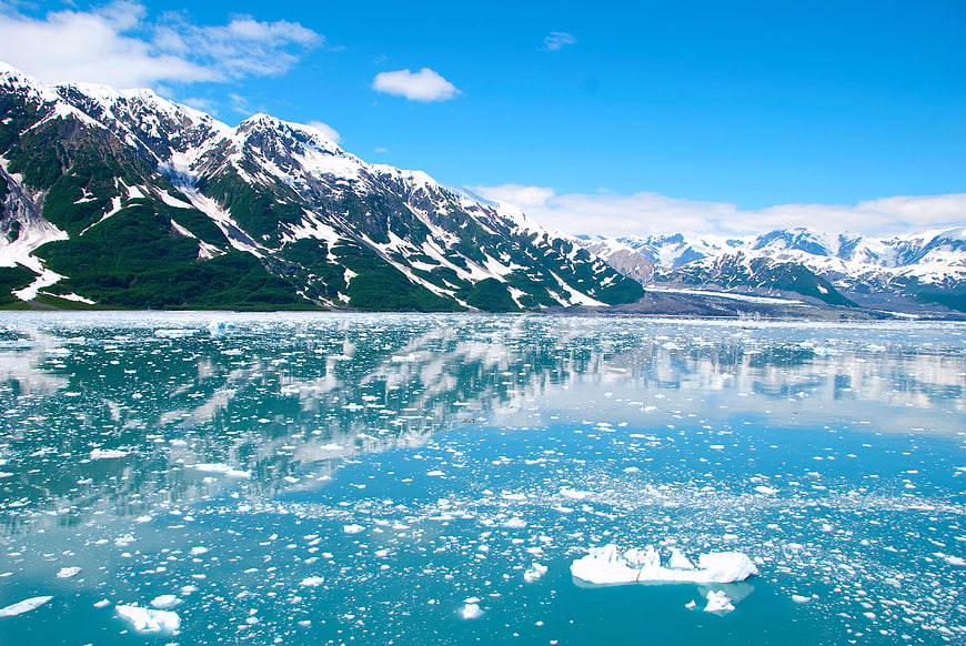 Snowy Mountains Reflected in Glacial Lake with Icebergs